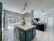 Open-concept floor plan with island seating, a living area, and views of the screened pool at 1426 Park Park, Haines City, FL 33844