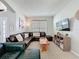 Comfortable living room featuring a sectional sofa, large window, and media center at 1426 Park Park, Haines City, FL 33844