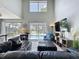 Bright living room with high ceilings, a view of the pool, and a large sectional couch at 1426 Park Park, Haines City, FL 33844