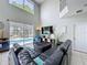 Open-concept living area featuring high ceilings, large windows, and access to outdoor pool area at 1426 Park Park, Haines City, FL 33844