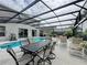 Relax poolside on the screened patio with dining and lounge areas, ideal for outdoor enjoyment and entertaining at 1426 Park Park, Haines City, FL 33844