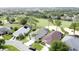 Aerial view of several single-Gathering homes in a neighborhood, with golf course in the background at 1428 Park Pl, Haines City, FL 33844