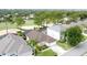 Aerial view of a single-Gathering home in a neighborhood, featuring a well-manicured lawn and a two-car garage at 1428 Park Pl, Haines City, FL 33844