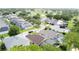 An aerial view shows a neighborhood with well-maintained homes and a golf course in the background at 1428 Park Pl, Haines City, FL 33844