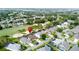 The aerial view highlights the property's prime location near a golf course, surrounded by trees and homes at 1428 Park Pl, Haines City, FL 33844