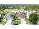Aerial view of a single-Gathering home in a neighborhood, featuring a well-manicured lawn and a two-car garage at 1428 Park Pl, Haines City, FL 33844