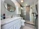 Modern bathroom featuring stylish tiling, a marble countertop vanity, and a glass-enclosed shower at 1428 Park Pl, Haines City, FL 33844
