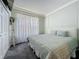 Comfortable bedroom with paneled walls, queen bed, soft lighting and ample closet space at 1428 Park Pl, Haines City, FL 33844