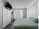 Serene bedroom with a TV, soft lighting, ample storage and paneled walls for a modern touch at 1428 Park Pl, Haines City, FL 33844