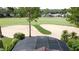 Aerial view of a golf course with a sand trap and green, with residential properties in the background at 1428 Park Pl, Haines City, FL 33844