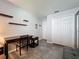 This home office features a wooden desk, shelves, and gray tile flooring for a modern and functional workspace at 1428 Park Pl, Haines City, FL 33844