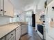 Efficient kitchen featuring white cabinets, modern appliances, tile backsplash, and ample counter space at 1428 Park Pl, Haines City, FL 33844