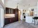 Open kitchen layout featuring dark cabinets, granite countertops and breakfast bar seating at 1428 Park Pl, Haines City, FL 33844