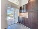 Kitchen with sliding door access to the pool area, abundant cabinet space, and granite countertops at 1428 Park Pl, Haines City, FL 33844