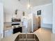 Bright kitchen features white cabinets, stainless steel appliances, and a large sink at 1428 Park Pl, Haines City, FL 33844