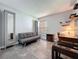 Cozy living room with a convertible sofa, wardrobe, built-in shelves, and a sunlit window at 1428 Park Pl, Haines City, FL 33844