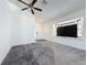 Bright living room featuring plush carpeting, a modern ceiling fan, and a large picture window at 1428 Park Pl, Haines City, FL 33844