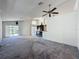 Open living space offering plush carpeting, a ceiling fan, and seamless access to the outdoors at 1428 Park Pl, Haines City, FL 33844