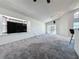 Expansive living area boasting plush carpeting, modern lighting, and seamless access to the outdoors at 1428 Park Pl, Haines City, FL 33844