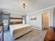 Bright main bedroom showcasing a queen-size bed, neutral color palette, and a decorative ceiling light at 1428 Park Pl, Haines City, FL 33844