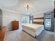 Bright main bedroom showcasing a queen-size bed, neutral color palette, and outdoor patio access at 1428 Park Pl, Haines City, FL 33844