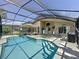 Step into your outdoor oasis featuring a screened-in pool, covered patio, and poolside dining area at 1428 Park Pl, Haines City, FL 33844