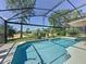 Relax and unwind in this private, screened-in pool with a view of the beautifully landscaped backyard at 1428 Park Pl, Haines City, FL 33844