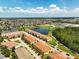 Expansive aerial view showcases townhomes, a large pond, and neighborhood amenities in a well-planned community at 14344 Swanley St, Orlando, FL 32832