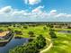 Scenic aerial view of lush golf course community with water features and beautiful landscaping at 14344 Swanley St, Orlando, FL 32832