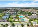 Community aerial view showcasing swimming pools, tennis courts, and surrounding homes at 14344 Swanley St, Orlando, FL 32832