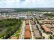 High aerial of townhome community with lake and green space, with shopping and other amenities nearby at 14344 Swanley St, Orlando, FL 32832