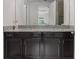 Modern bathroom vanity featuring granite countertops, double sinks and dark cabinetry at 14344 Swanley St, Orlando, FL 32832