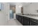 Large bathroom vanity with granite countertops, double sinks and enclosed shower at 14344 Swanley St, Orlando, FL 32832