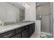 Beautiful bathroom featuring double sinks, granite countertops, and a glass shower at 14344 Swanley St, Orlando, FL 32832