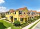 Stunning two-story townhouse with a red tile roof and lush landscaping in a well-maintained community at 14344 Swanley St, Orlando, FL 32832