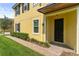 Welcoming front exterior featuring manicured shrubs, a brick-paved walkway, and a black front door at 14344 Swanley St, Orlando, FL 32832