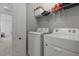 Laundry room featuring a white washer and dryer, wire shelving, and access to another room at 14344 Swanley St, Orlando, FL 32832