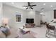 Open living space boasting tile floors, a comfortable gray sofa, and views into the modern kitchen at 14344 Swanley St, Orlando, FL 32832