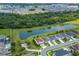 Stunning aerial view of homes near a pond and trees, creating a tranquil, picturesque environment for relaxed living at 14421 Ward Rd, Orlando, FL 32824