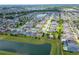 Expansive aerial view of a community next to a pond, providing a serene and connected neighborhood environment at 14421 Ward Rd, Orlando, FL 32824