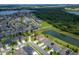 Gorgeous aerial view showcasing neighborhood homes near a pond, offering a blend of community and peaceful waterfront living at 14421 Ward Rd, Orlando, FL 32824