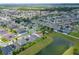 Extensive aerial view of a large neighborhood beside a pond, ideal for those seeking a friendly and nature-rich community at 14421 Ward Rd, Orlando, FL 32824