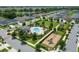 Aerial view showcases community pool, playground, green space, and well-manicured landscaping in a desirable neighborhood at 14421 Ward Rd, Orlando, FL 32824