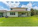 Well-maintained backyard with a covered patio, ceiling fans, and lush green lawn offers a relaxing outdoor space at 14421 Ward Rd, Orlando, FL 32824