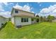Well-maintained backyard with a covered patio, ceiling fans, and lush green lawn offers a relaxing outdoor space at 14421 Ward Rd, Orlando, FL 32824