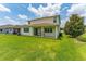 Well-maintained backyard with a covered patio, ceiling fans, and lush green lawn offers a relaxing outdoor space at 14421 Ward Rd, Orlando, FL 32824