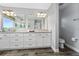 Bathroom featuring a double sink, modern vanity, toilet and an enclosed shower at 14421 Ward Rd, Orlando, FL 32824