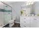 This bathroom features a shower with glass doors, white drawers, and modern decor at 14421 Ward Rd, Orlando, FL 32824