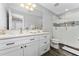 This bathroom features a double sink, a shower with glass doors, and modern decor at 14421 Ward Rd, Orlando, FL 32824