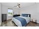 This bedroom features a window, hardwood floors, a ceiling fan, and dark wood furniture at 14421 Ward Rd, Orlando, FL 32824